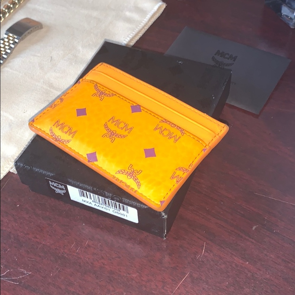I am selling my orange and purple mcm card holder